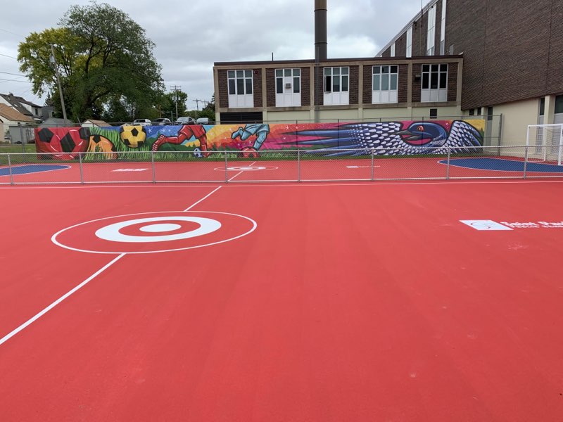 the mini-pitches at johnson senior high school are bright red with the target bullseye logo in the center of the pitches