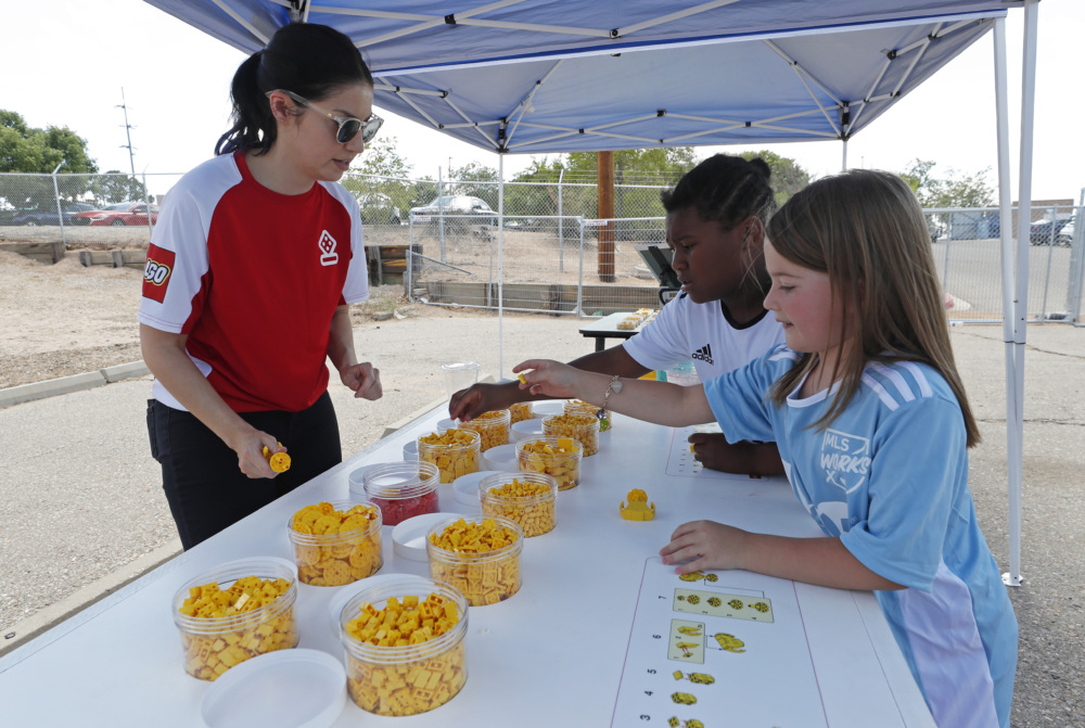 Kids assemble Women's World Cup trophies at the mini-pitch opening in New Mexico