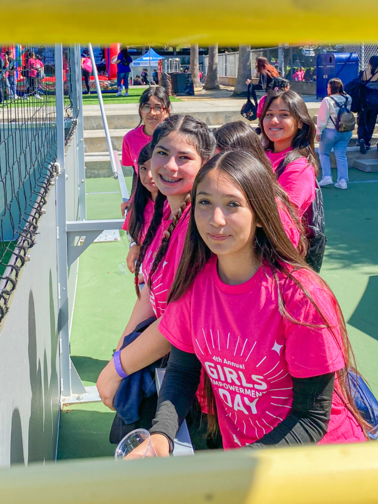 Group photo of girls smiling on the sidelines