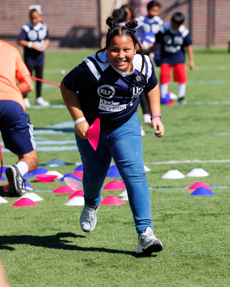 Girl runs toward camera smiling