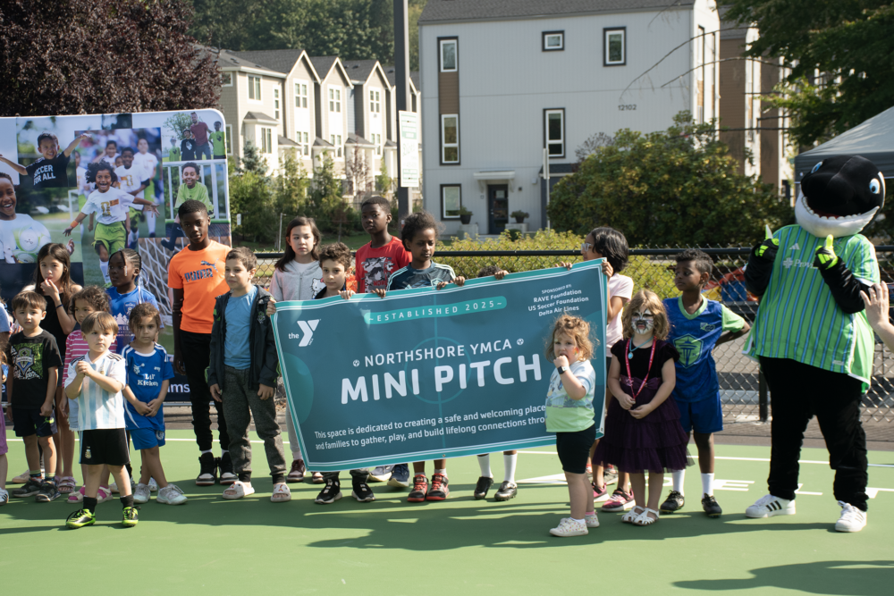 Group pose with mini-pitch banner