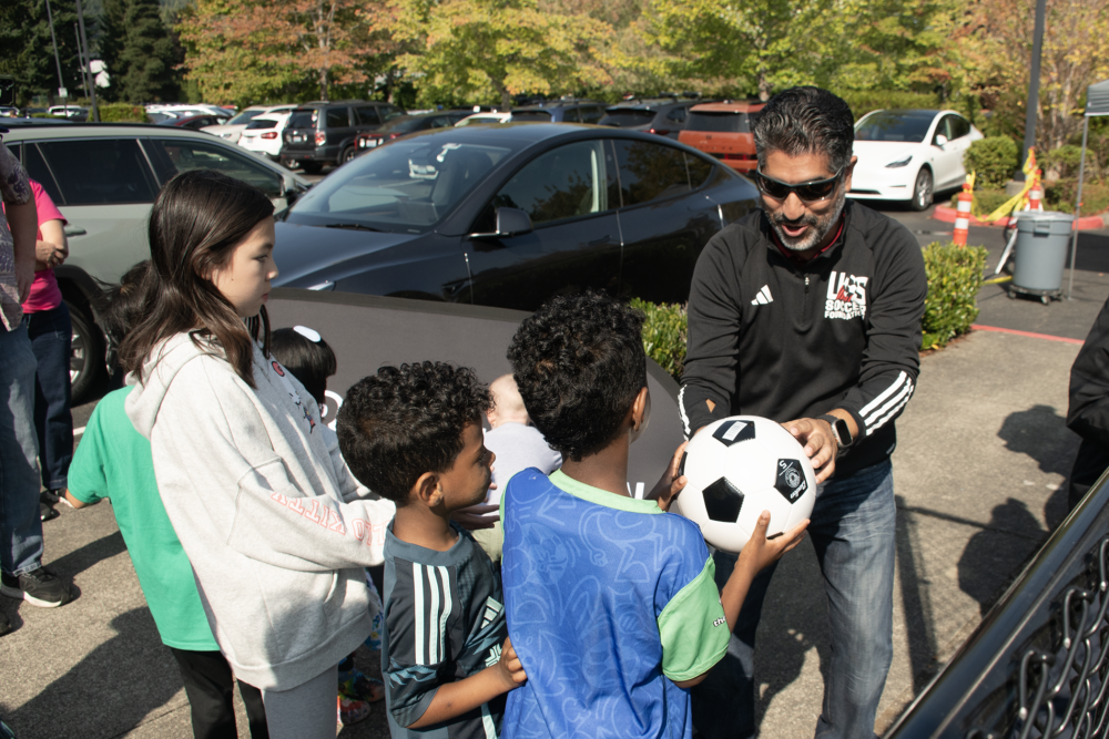Kids getting soccer ball signed