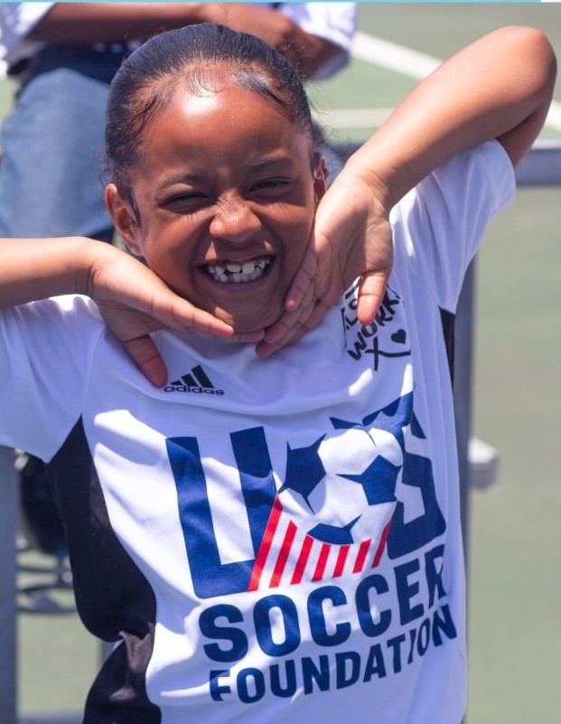 Girl smiling in U.S. Soccer Foundation jersey