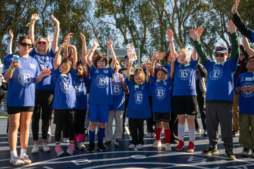 Kids cheering at mini-pitch opening.