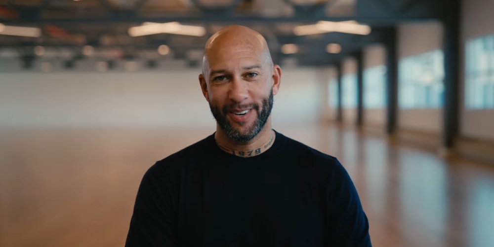 Man in black shirt smiling