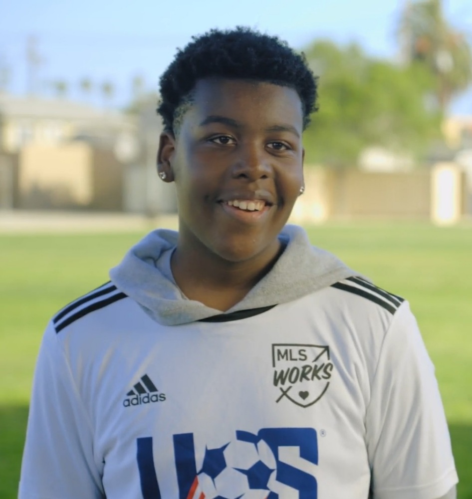 Jameer stands on pitch, wearing a U.S. Soccer Foundation jersey.
