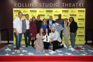 Staff and 1994 Team in front of the Rollins Studio Theatre sign.
