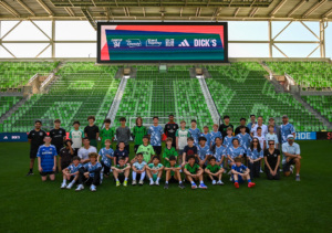 Kids & coach-mentors pose at SXSW 2026 community event