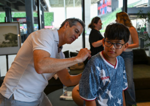 Member of the 1994 Men's National Team signs kids' jersey at 2026 SXSW community event