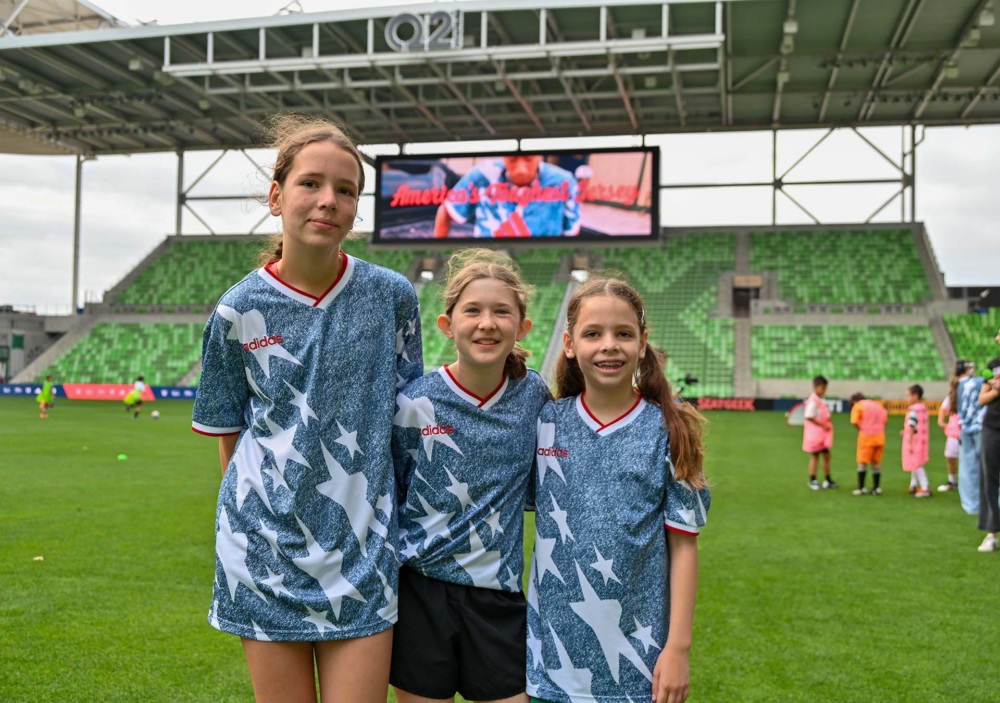 Girls stand on pitch for SXSW community event in Austin