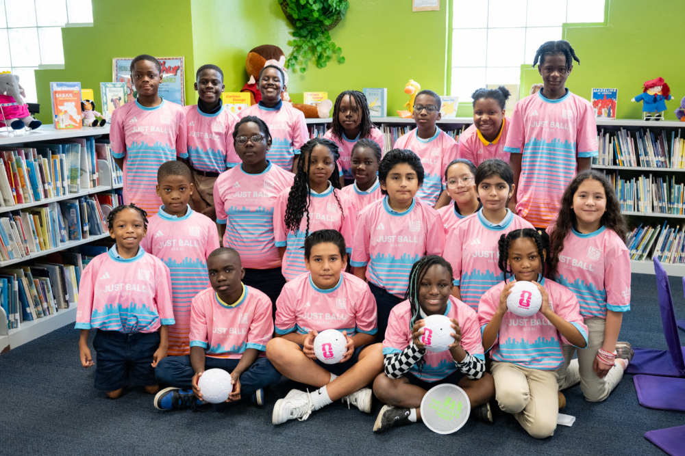 Kids pose in the library ahead of the Oak Grove Elementary mini-pitch opening.